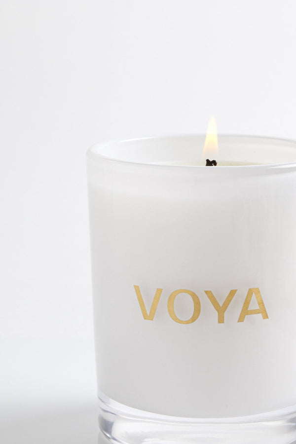 voya naturally scented luxury candle, cedarwood and bergamot scent, lit with flame